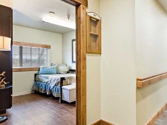 A cozy room with a single bed and a wooden floor.