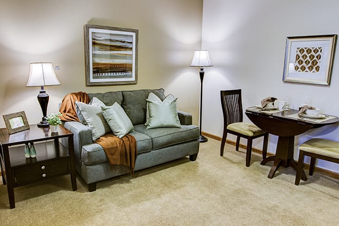 A cozy living room featuring a comfortable sofa, stylish lamps, and elegant decor.