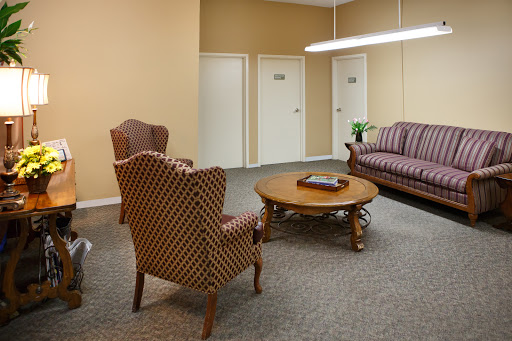 A cozy waiting area featuring comfortable seating and a warm color palette.