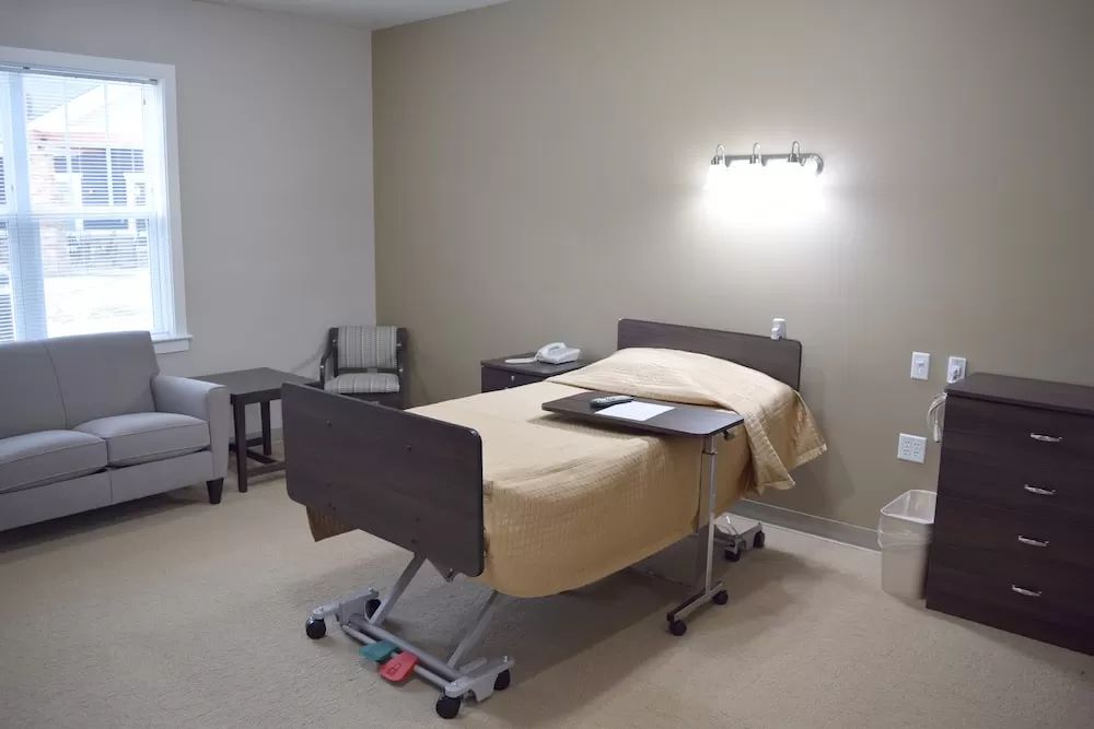 A clean and organized hospital room with a single patient bed.
