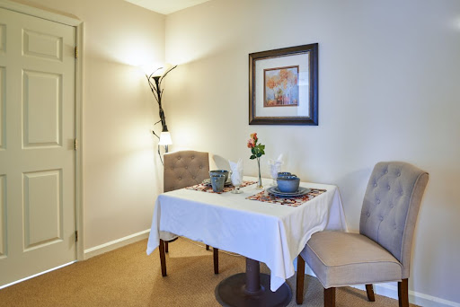 A cozy dining area featuring a neatly set table with decorative elements, perfect for intimate meals.