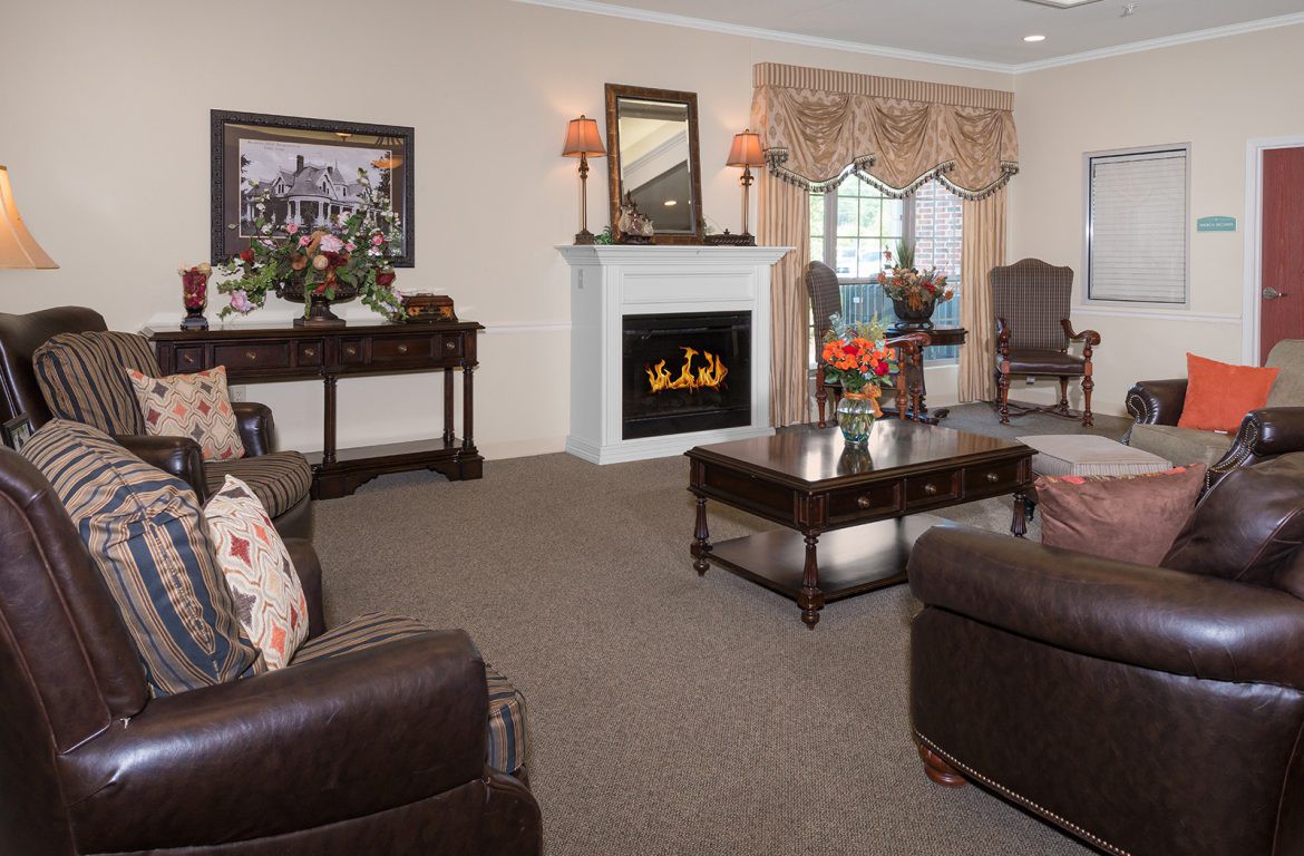 A traditional living room with a cozy fireplace and elegant furnishings.