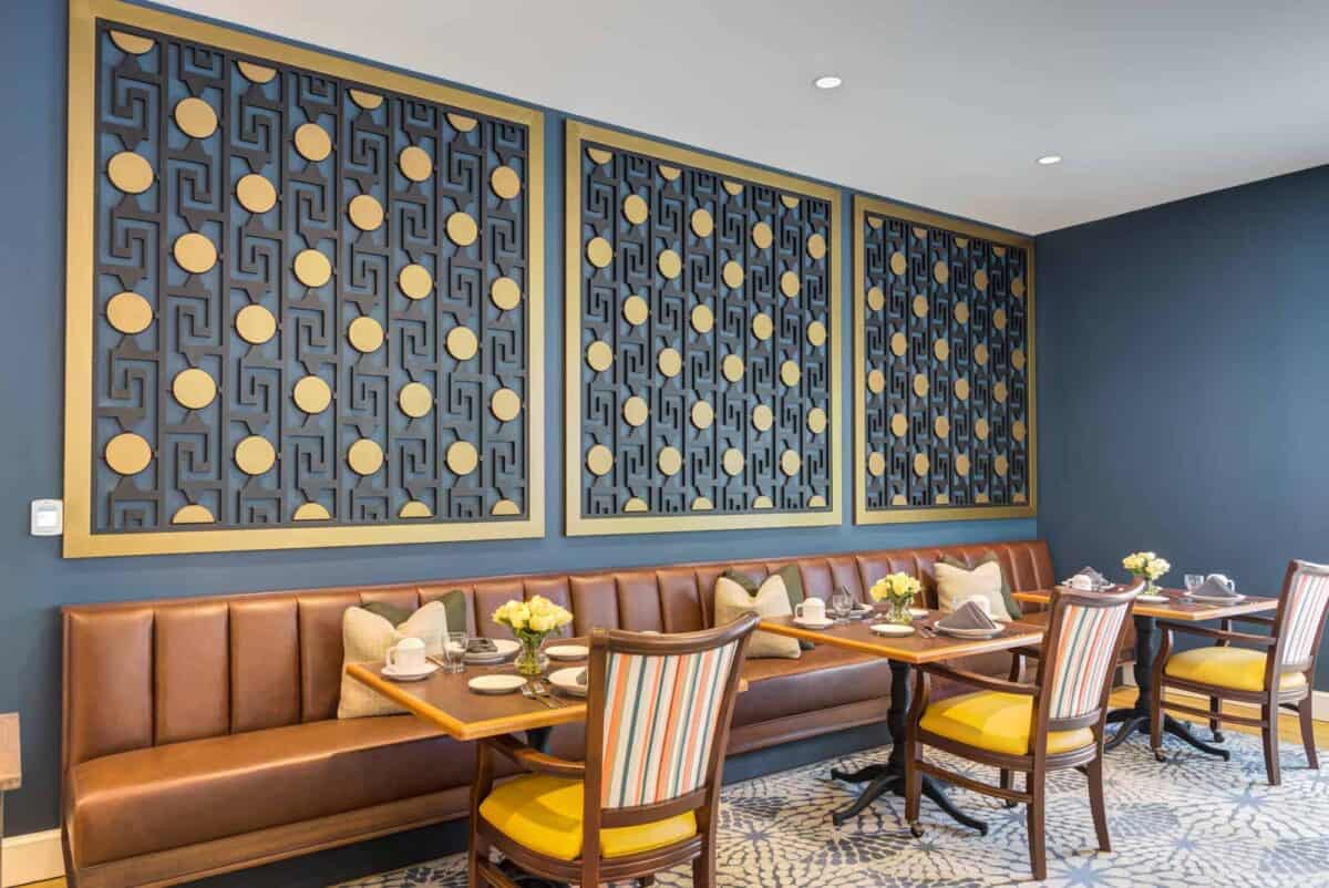 A stylish restaurant dining area featuring elegant wall art and comfortable seating.