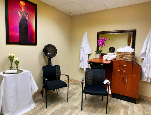 A serene waiting area in a spa, featuring comfortable chairs and calming decor.