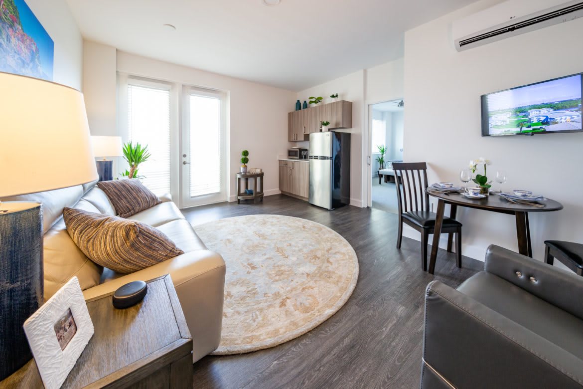 A modern and cozy apartment living space with a small kitchen area.