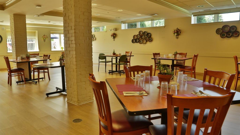 An empty restaurant interior with neatly arranged tables and chairs.