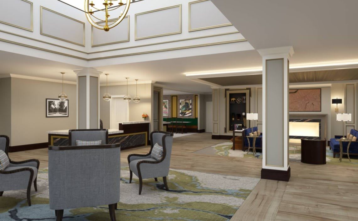 Elegant hotel lobby with a seating area and chandelier.