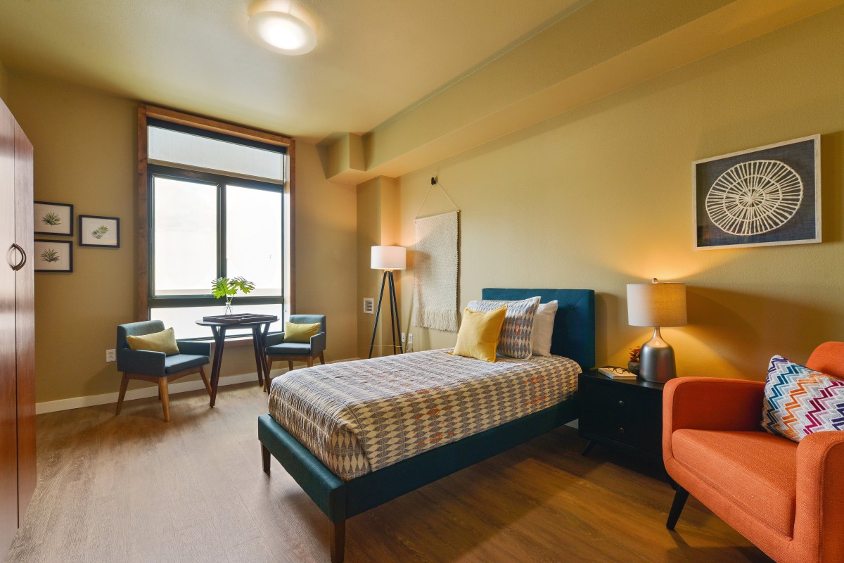 A modern and cozy bedroom with stylish furniture and natural light.