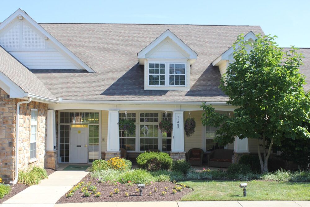A suburban house with a landscaped garden and a welcoming porch.