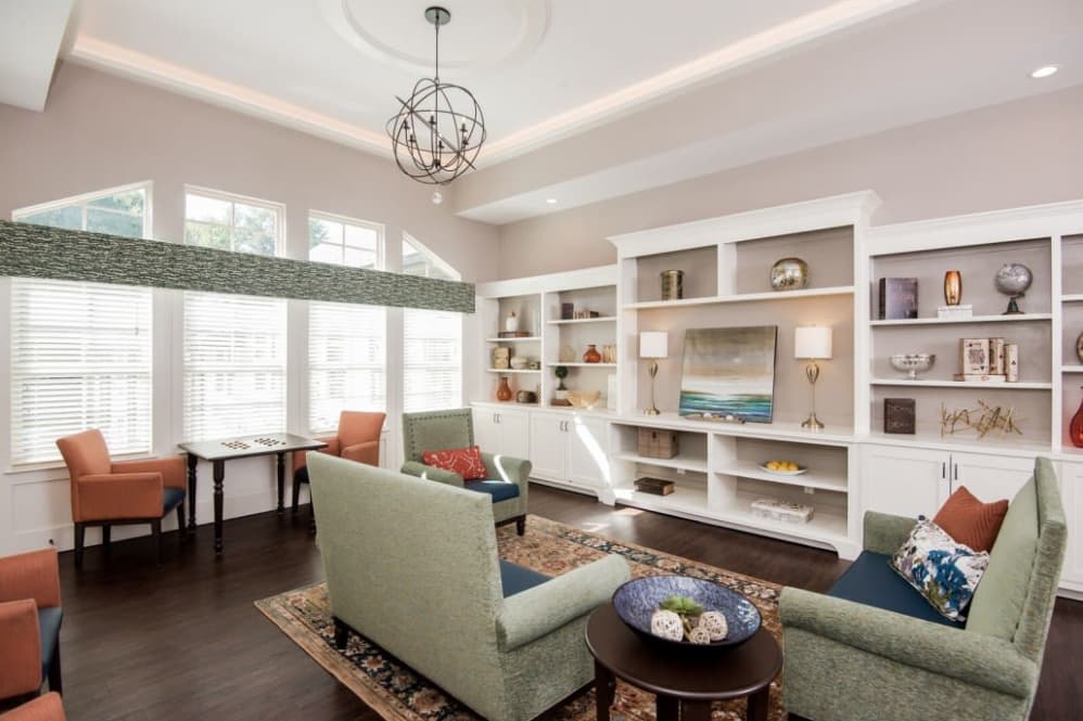 A cozy and modern living room with comfortable seating and elegant shelving.