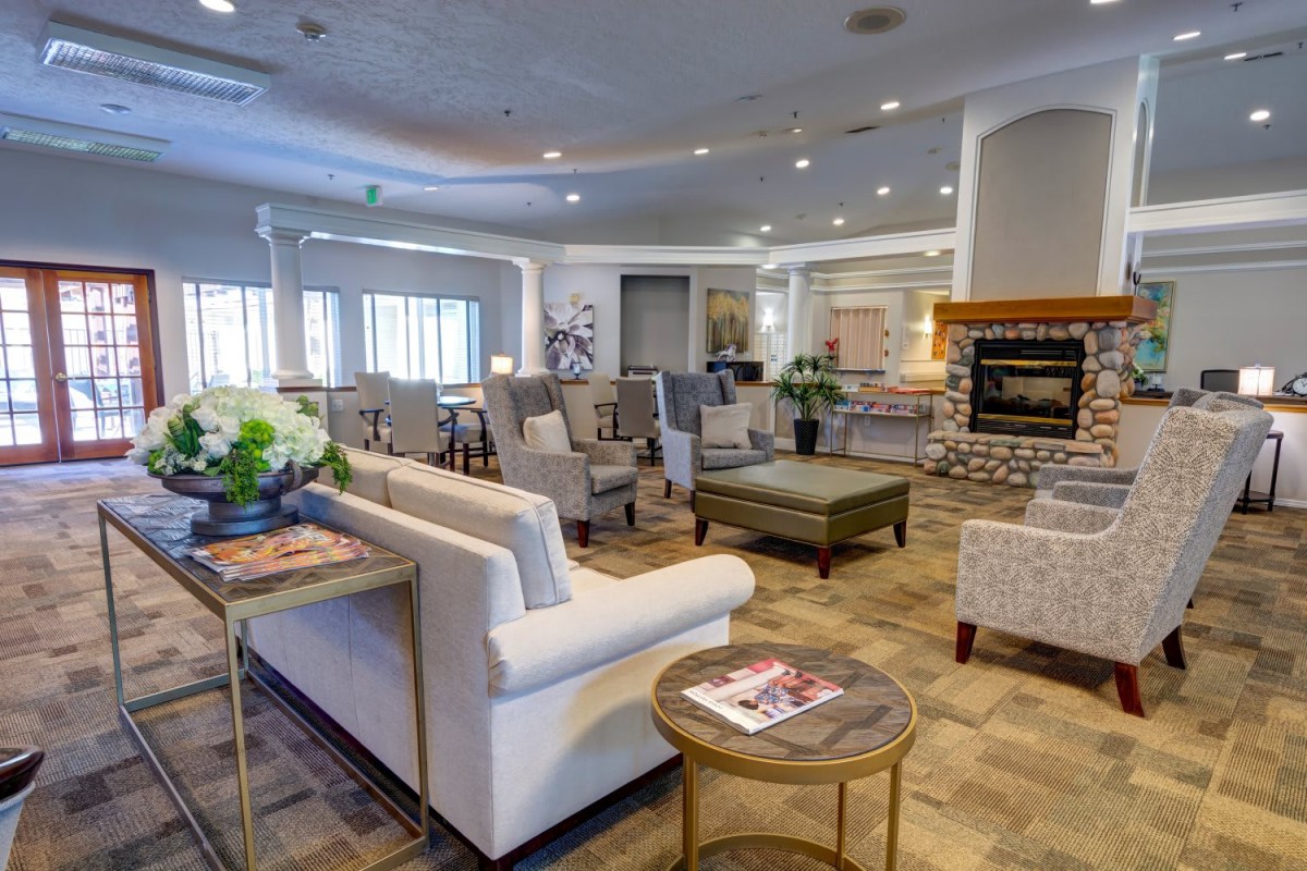 A spacious living room area with comfortable seating and a cozy fireplace.