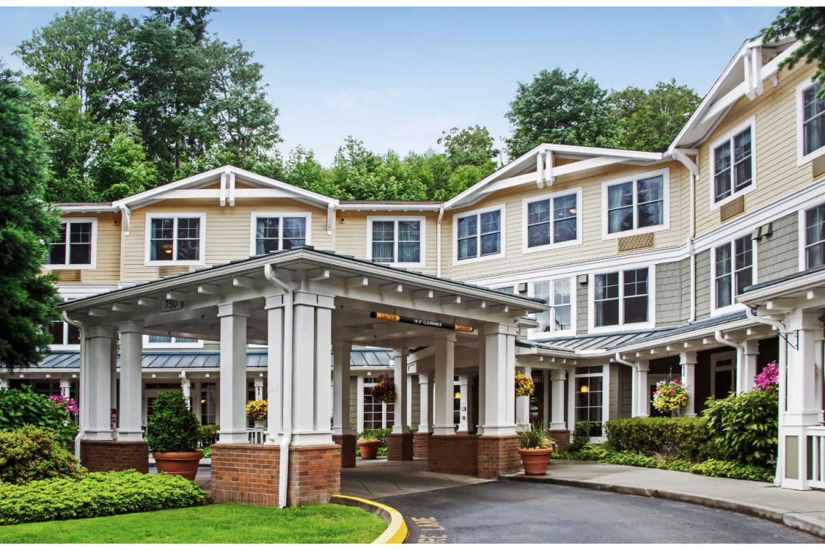 A elegant exterior view of a residential building with a covered entrance.