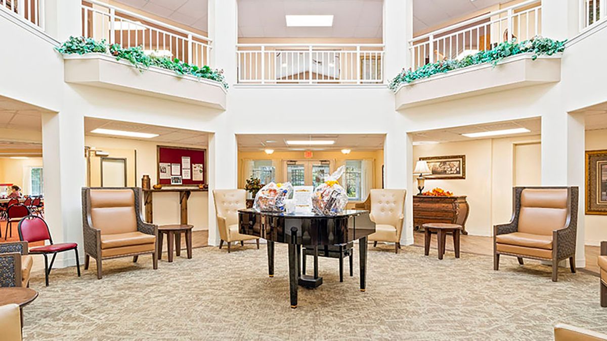 A spacious lobby featuring a grand piano and comfortable seating.