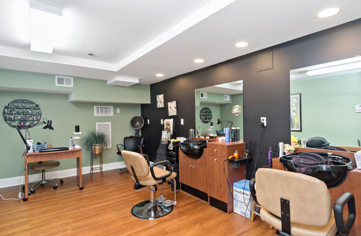 A cozy hair salon interior with styling chairs and mirrors.