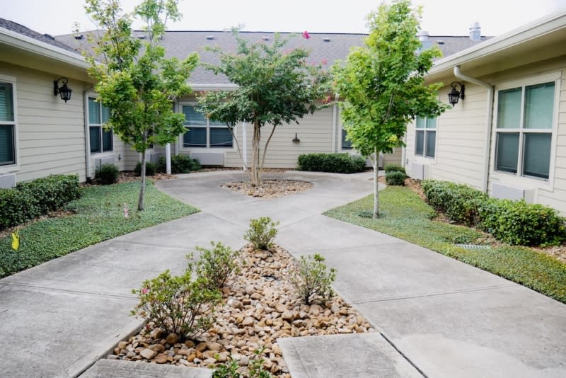 A serene courtyard featuring pathways and landscaped trees.