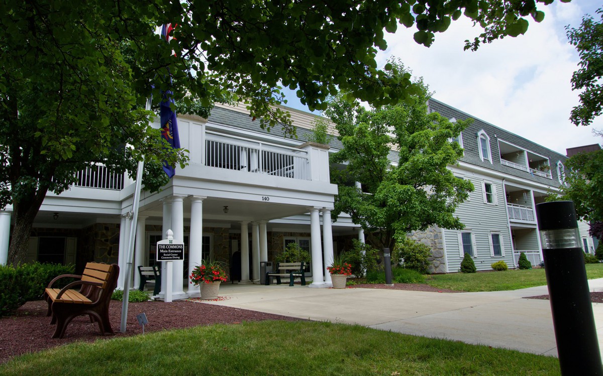 A view of a building entrance surrounded by trees.