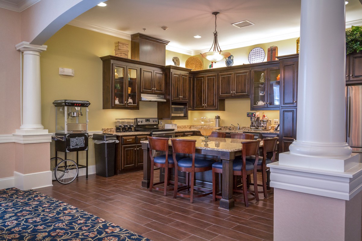 Spacious kitchen and dining area with wooden cabinets and modern appliances.