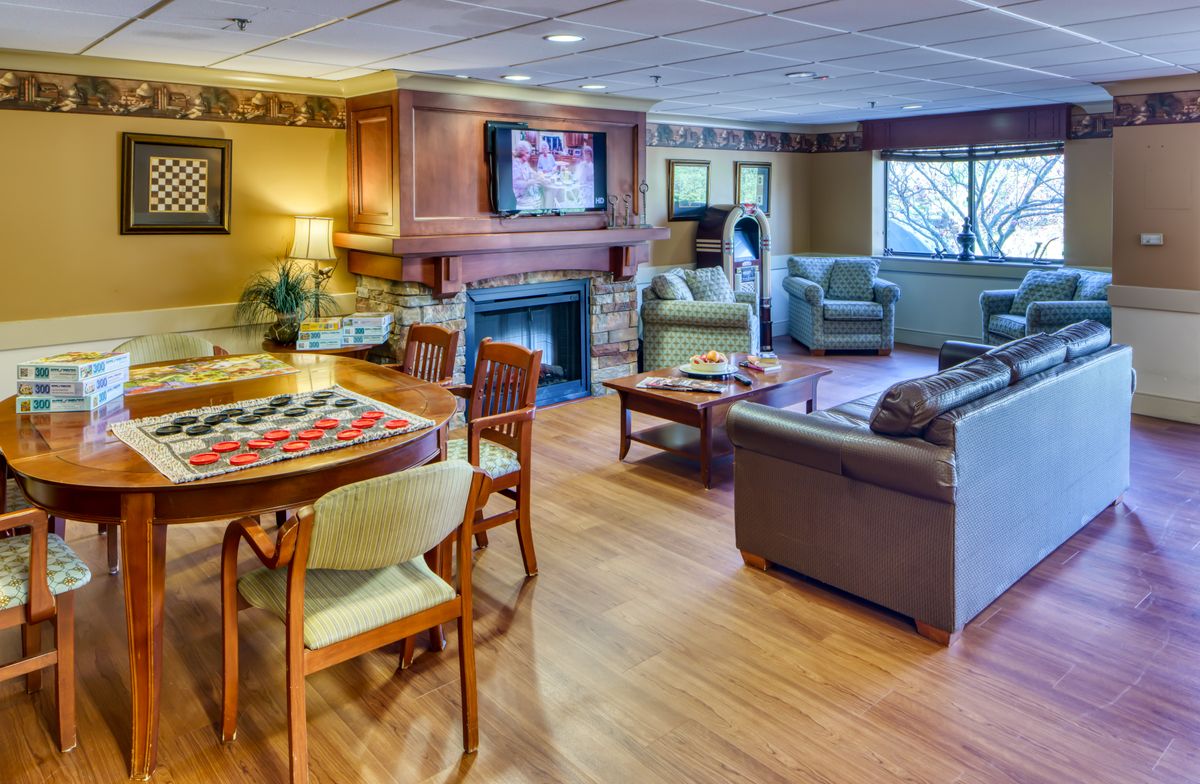 A cozy living room with a fireplace and comfortable seating.