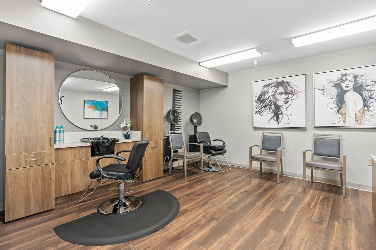 A modern hair salon with comfortable seating and stylish decor.