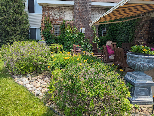 A serene garden space with vibrant flowers and comfortable outdoor seating.