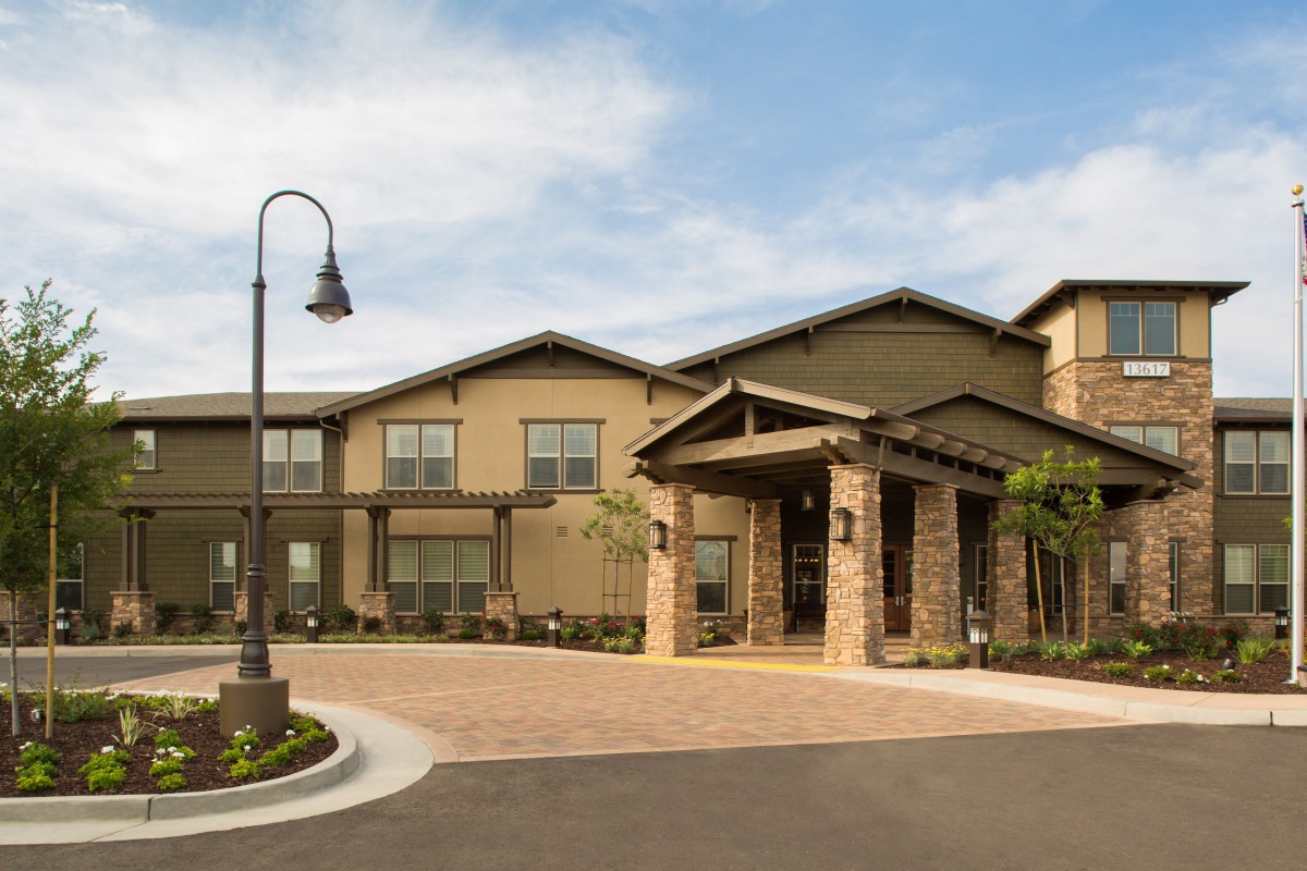 A modern residential building with a landscaped entrance.