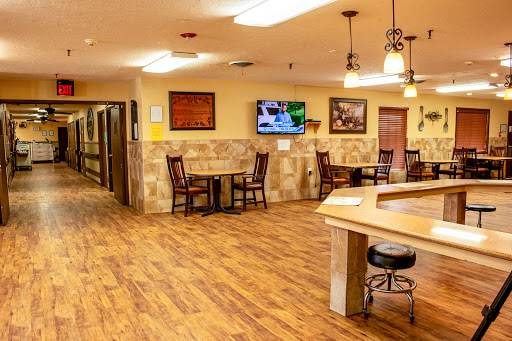 A cozy dining area featuring wooden flooring and a television.