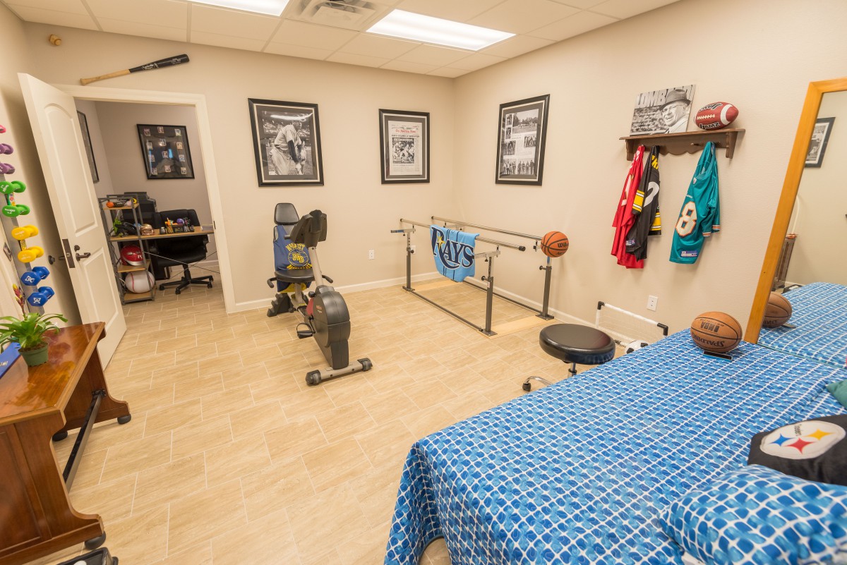 A well-equipped therapy room featuring exercise equipment and rehabilitation tools.