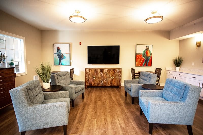 A cozy living room with modern furniture and a flat-screen TV.