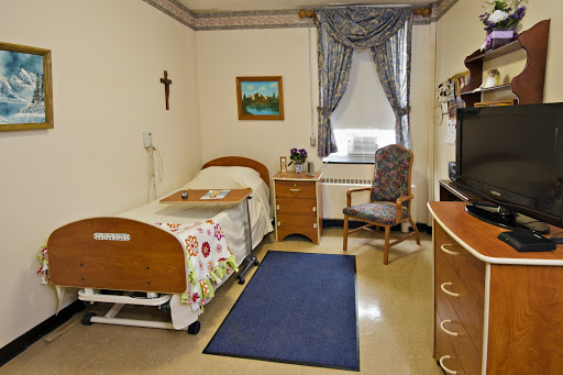 A well-organized hospital room featuring a patient bed, a chair, and decorative elements.