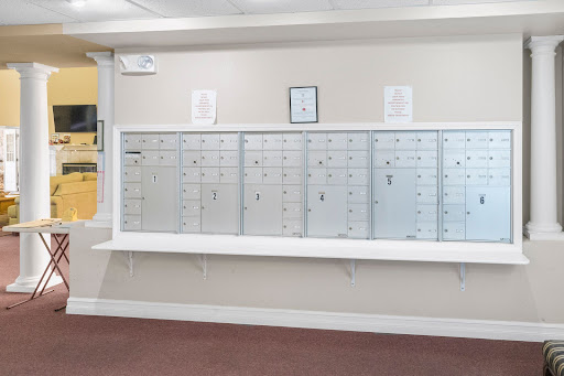 A row of silver mailboxes in a community postal area.