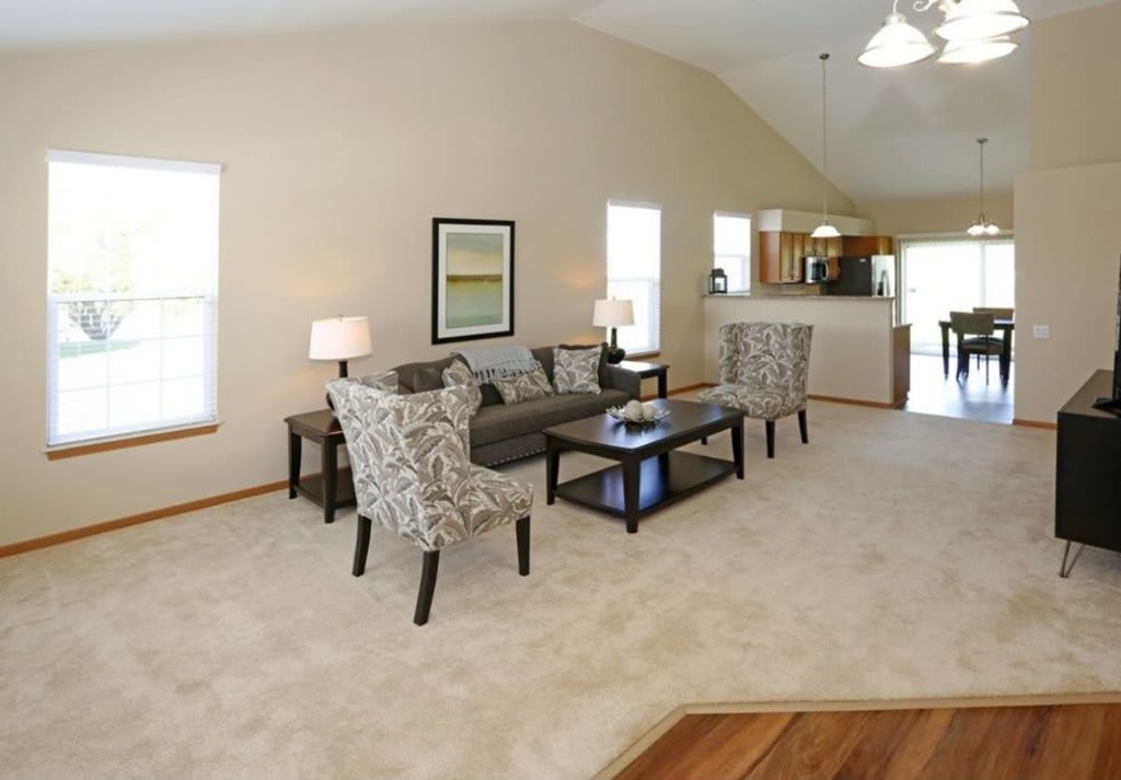 A spacious living room with a comfortable seating area and neutral color palette.