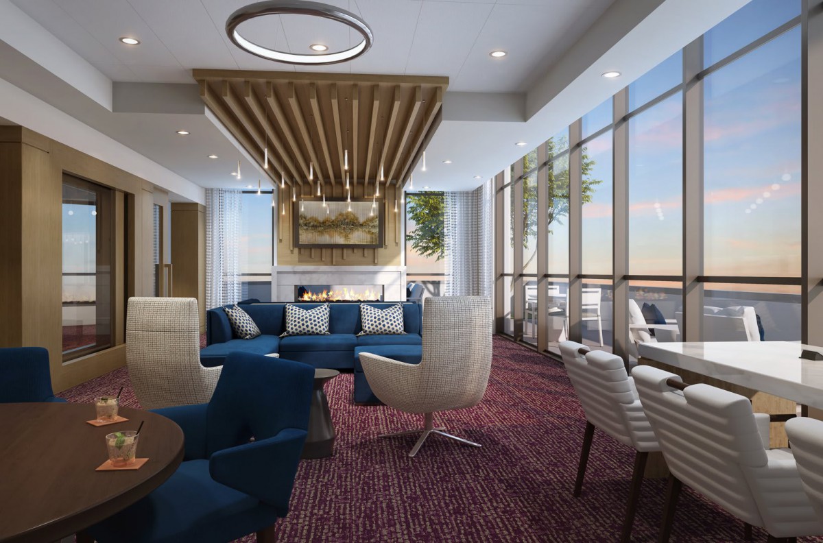 A modern lounge area with comfortable seating and large windows allowing natural light.