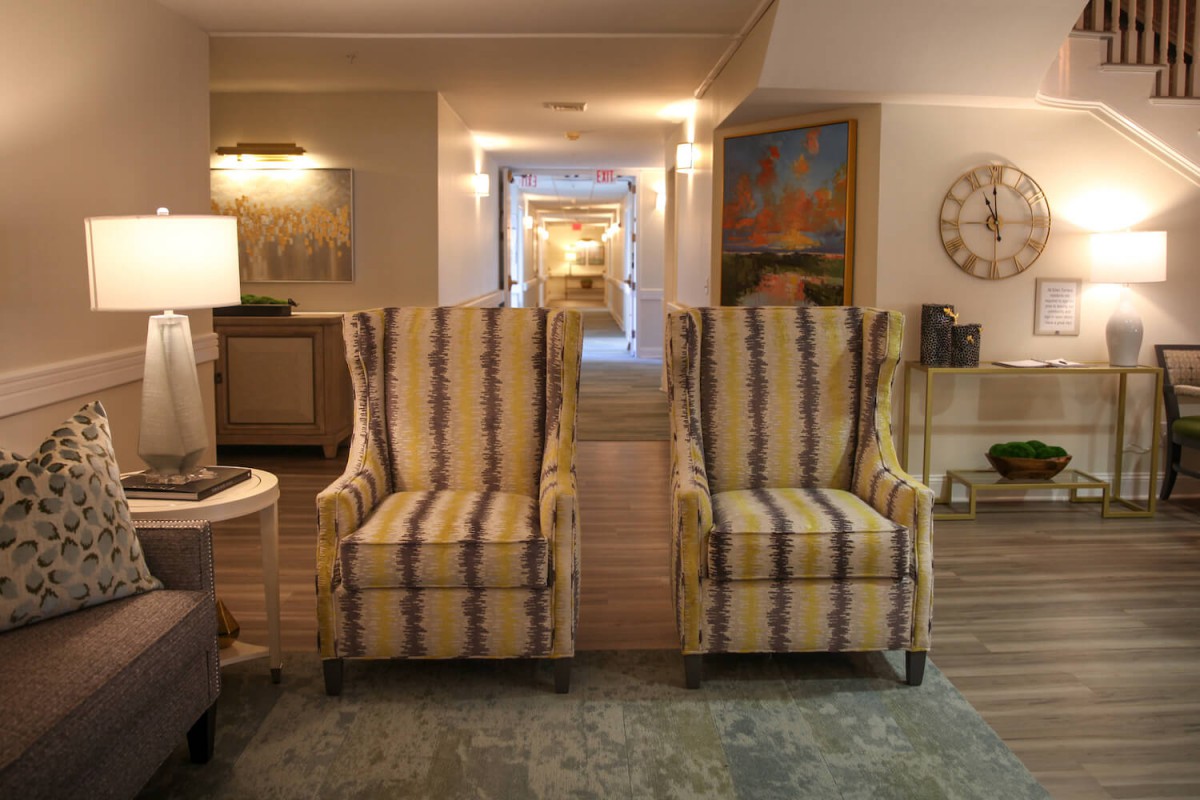 A cozy living room featuring two striped armchairs and elegant decor.