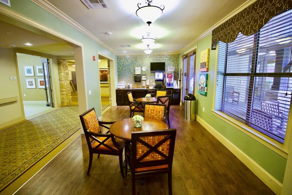 A cozy dining area with a table and chairs adjacent to a modern kitchen.
