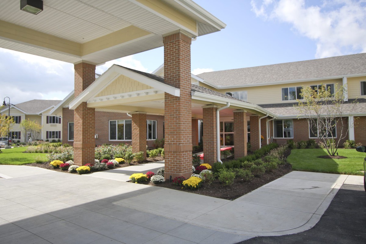 A well-maintained building with a covered entrance and landscaped surroundings.