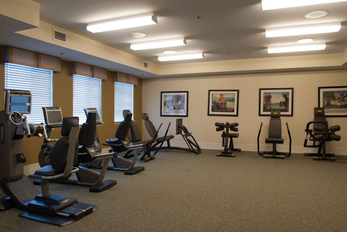 A well-equipped gym with various exercise machines arranged neatly.