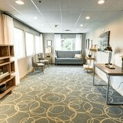 A modern office interior with sleek furniture and ample natural light.
