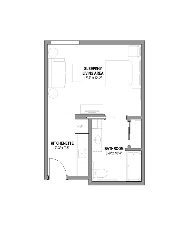 Studio apartment floor plan with designated sleeping/living area, kitchenette, and bathroom.