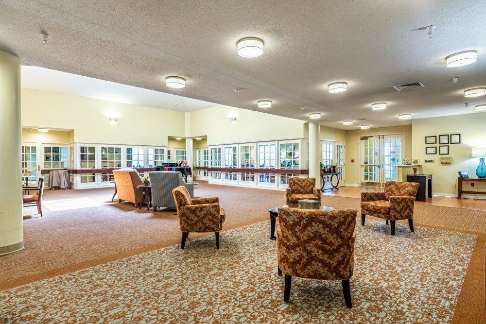 A spacious lobby area featuring comfortable seating and warm lighting.