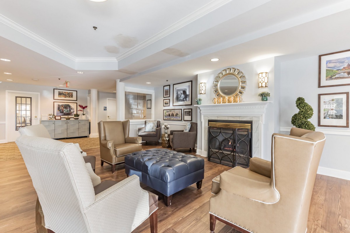 A cozy living room with comfortable seating and a warm fireplace.