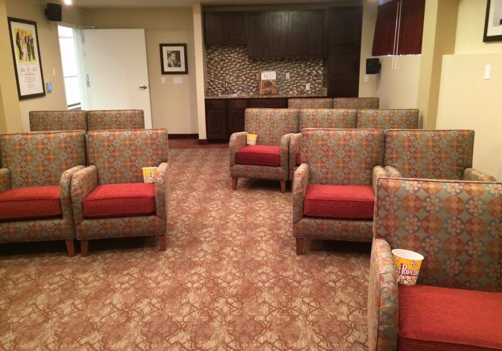 A well-organized waiting area with upholstered chairs and a decorative carpet.