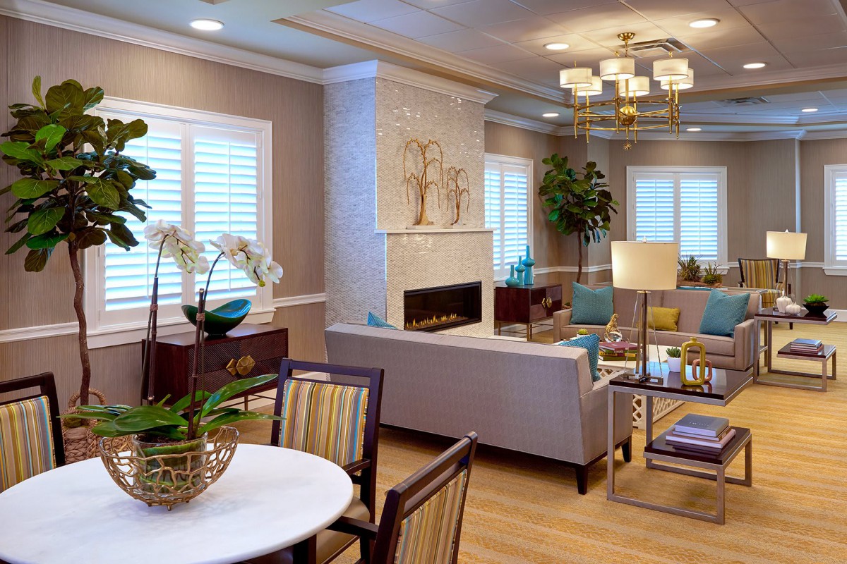 A modern living room with elegant decor, featuring a cozy fireplace and stylish furniture.