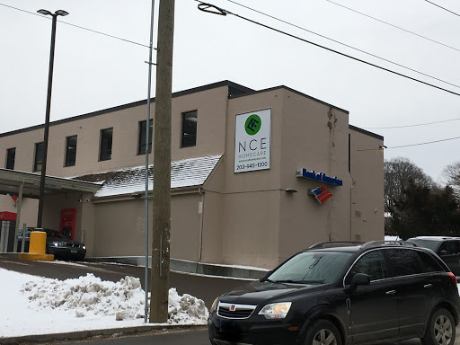 A building with signage partially covered in snow on a winter day.