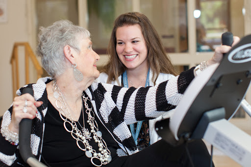 A warm moment between a caregiver and an elderly resident, sharing smiles and companionship.
