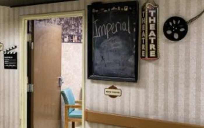 A room interior with a chalkboard labeled 'Imperial' and theater-themed decor.