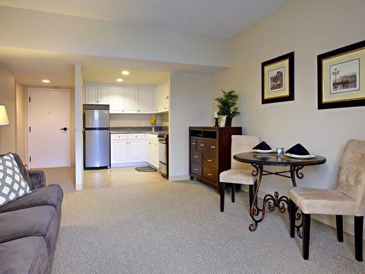 Cozy apartment interior featuring a small dining area and compact kitchen.