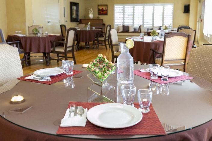 A neatly set dining table in a formal restaurant setting.