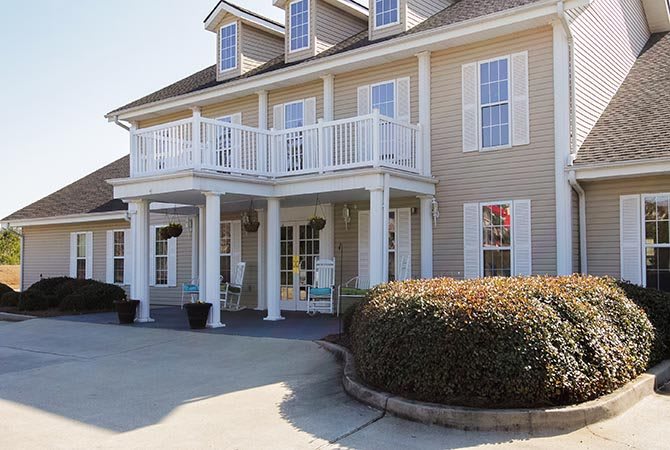 A two-story house with a front porch and upper balcony.