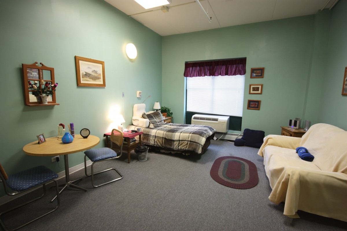 A cozy bedroom with two beds, decorated in a homey style.