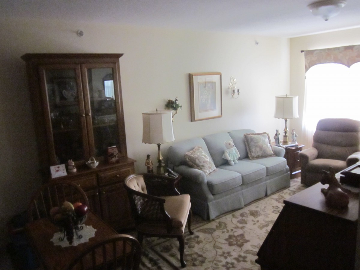 A cozy living room with a sofa, wooden furniture, and soft lighting.